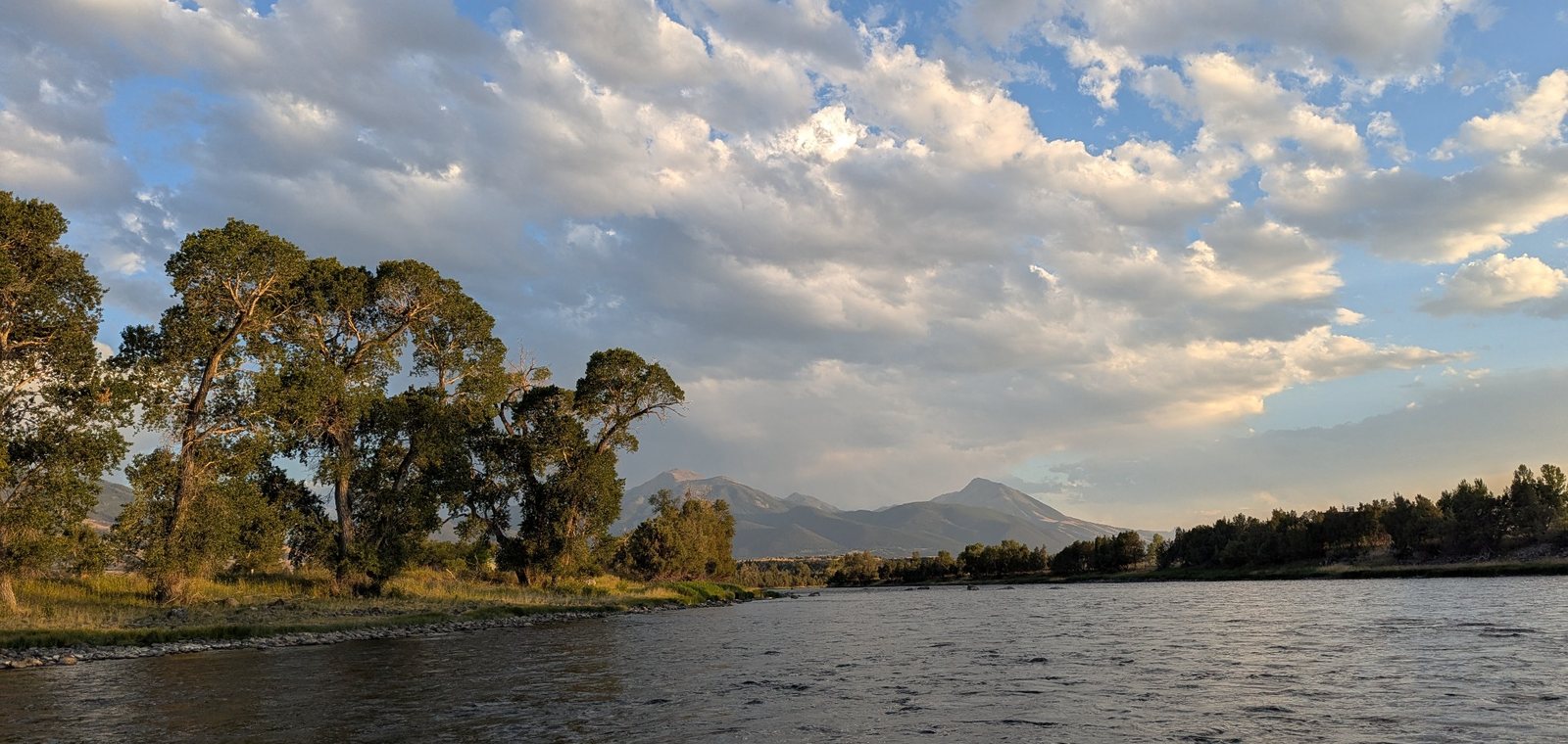 Montana river valley with mountains and evening clouds