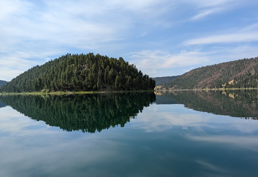 Calm Montana lake with trees reflected in the water